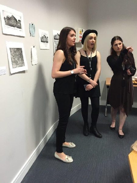 Participating art students discussing exhibition